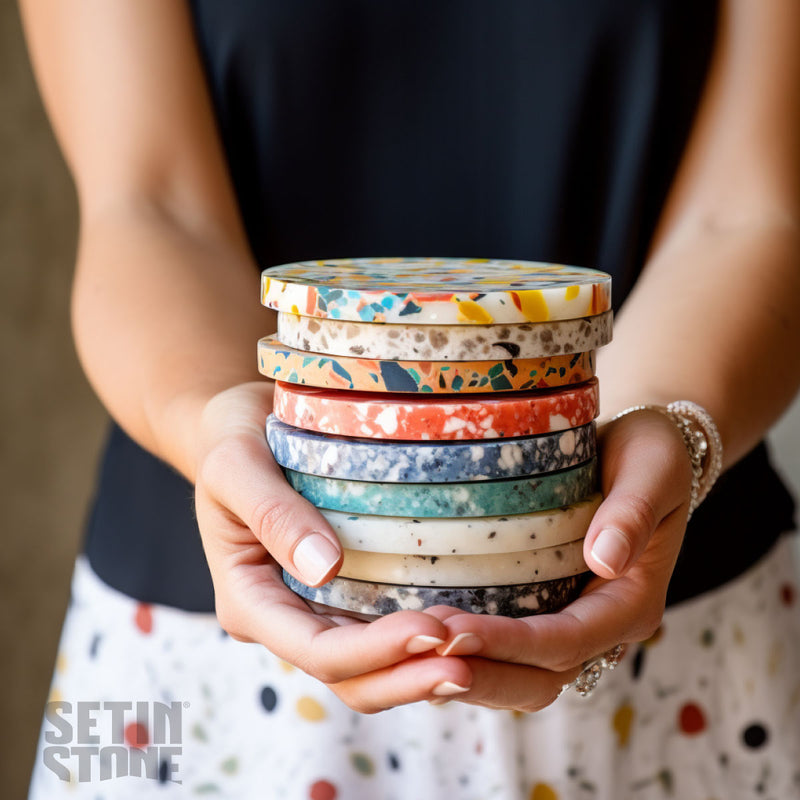 women holding a stack of colorful coasters made of setinstone in the terrazzo style